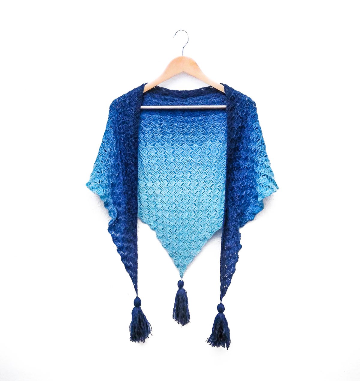 Blue gradient shawl draped over a clothes hanger